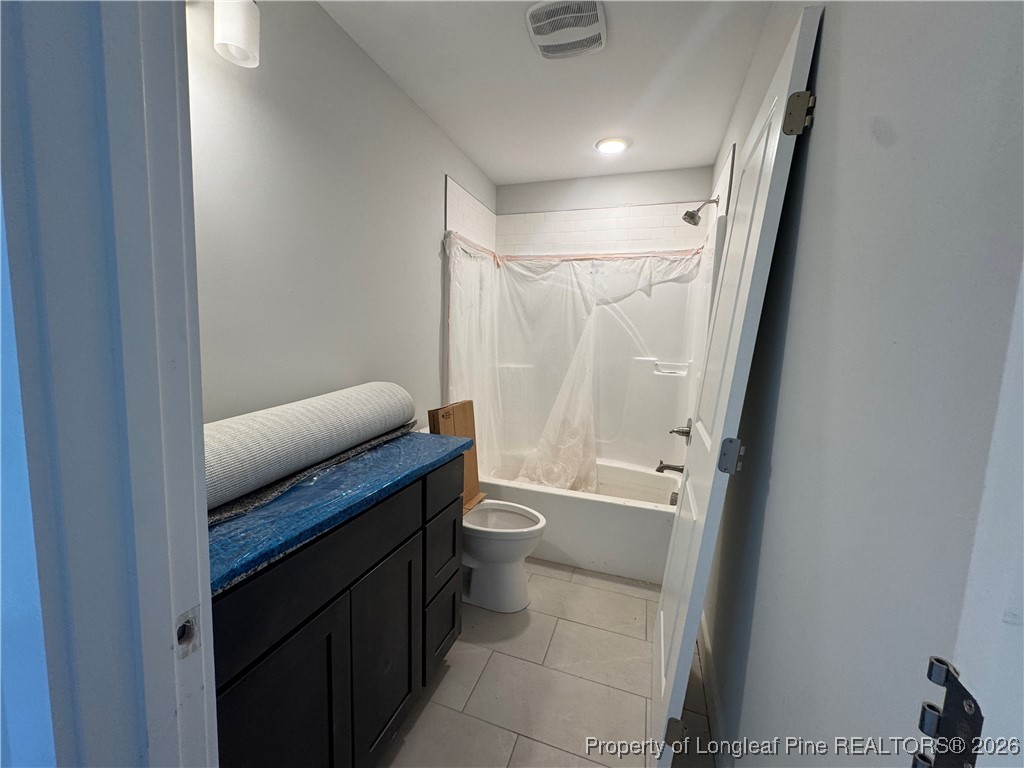 9806 Rockfish Road Raeford, NC 28376 - Photo 29 of 33 a bathroom with a granite countertop sink toilet and shower