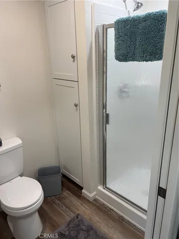 a bathroom with a toilet and a shower