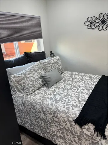 a bedroom with a bed and a window