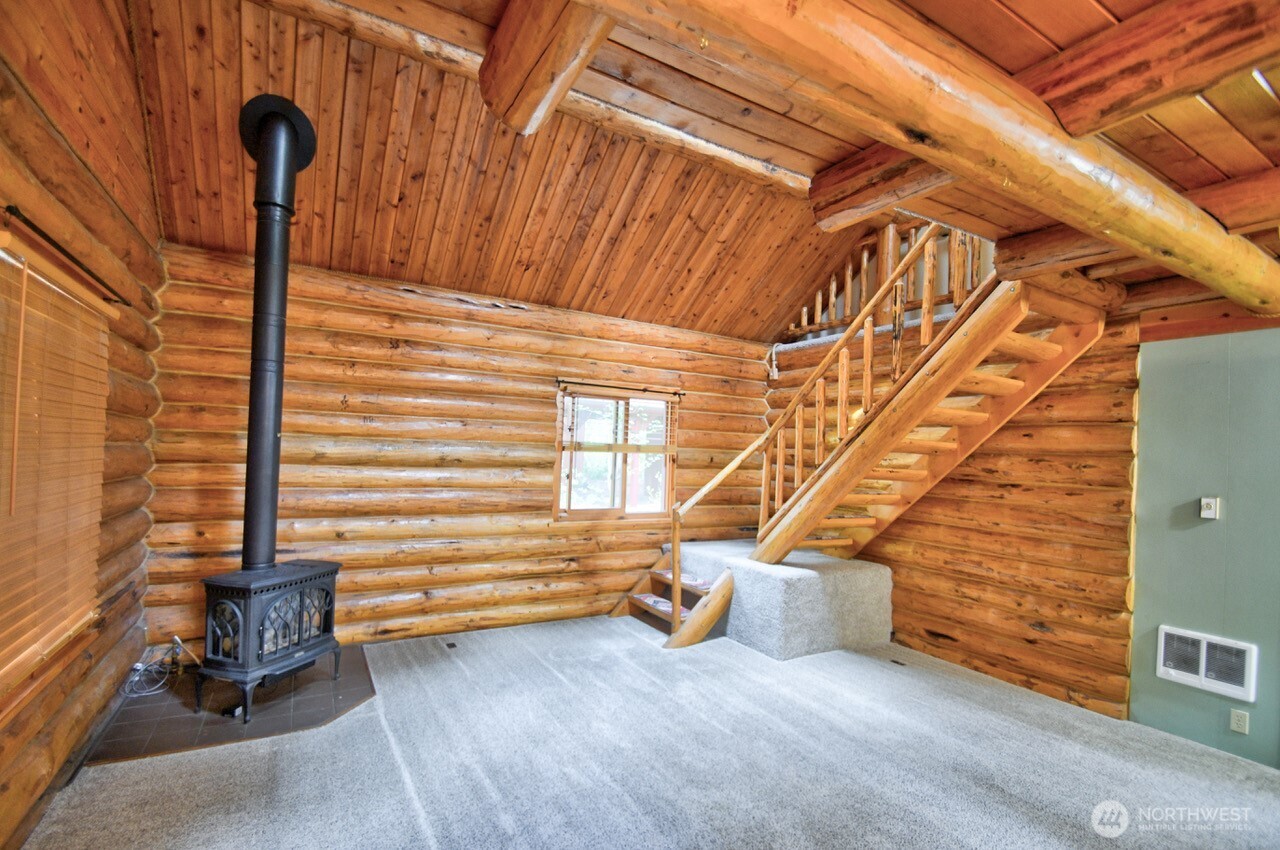 18114 Rampart Drive Southeast Yelm, WA 98597 - Photo 8 of 40 a view of a patio with table and chairs with wooden fence