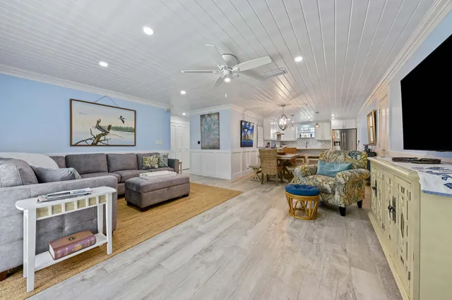 a bedroom with a bed and a dresser next to a window