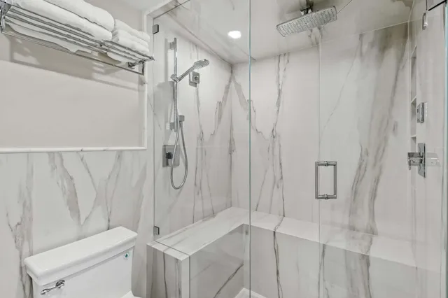 a bedroom with a bed a flat screen tv and dresser