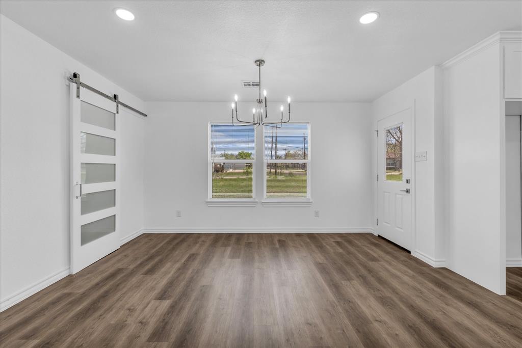204 North Wiebusch Street Riesel, TX 76682 - Photo 9 of 33 wooden floor in an empty room with a window