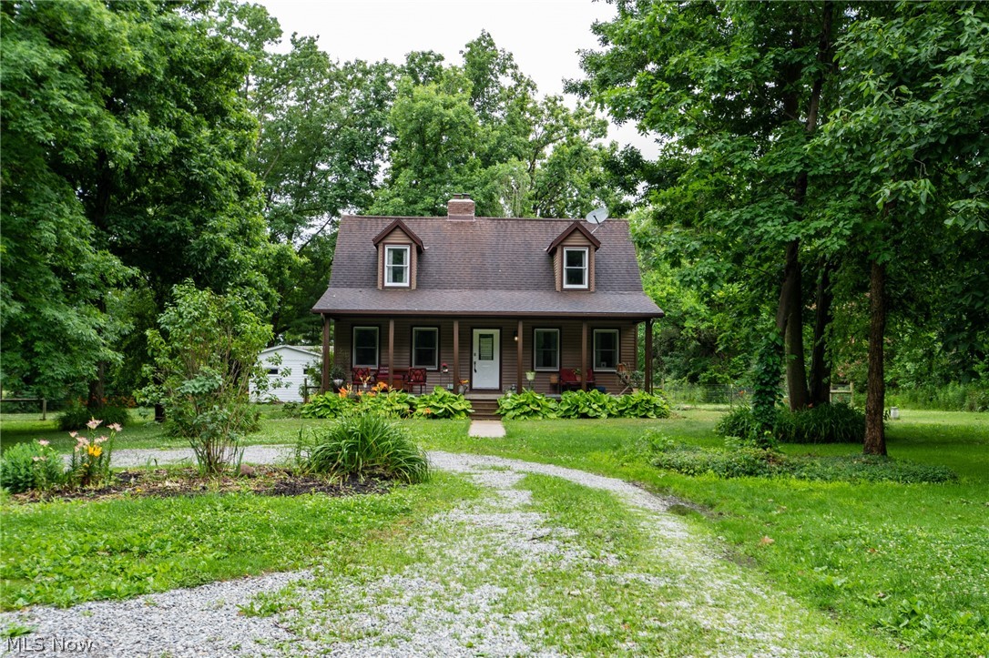 14027 Mayfield Road Huntsburg, OH 44046 - Photo 37 of 50 Charming cottage-style residence featuring a dormered roofline, a welcoming front porch, and a gravel driveway
