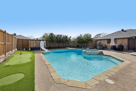 a view of a backyard with a garden and entertaining space