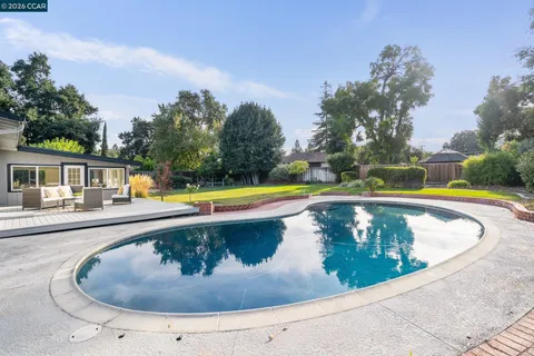 a view of a house with swimming pool and sitting area