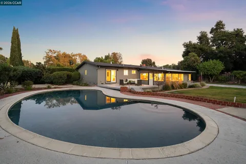 a view of swimming pool and trees in the background