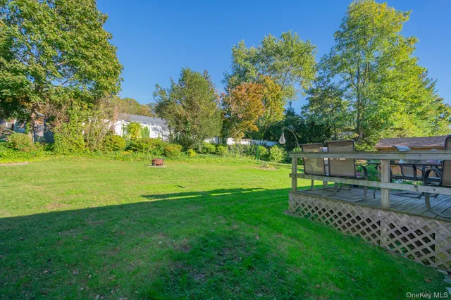 a view of a park and trees with a sitting area