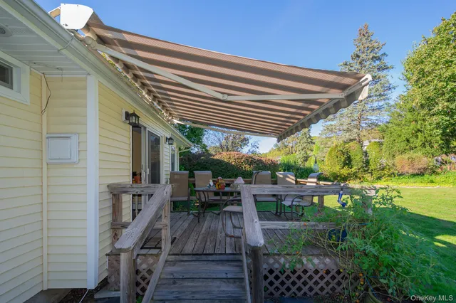 a view of a patio with chairs and potted plants
