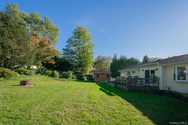 a view of a house with a backyard porch and sitting area