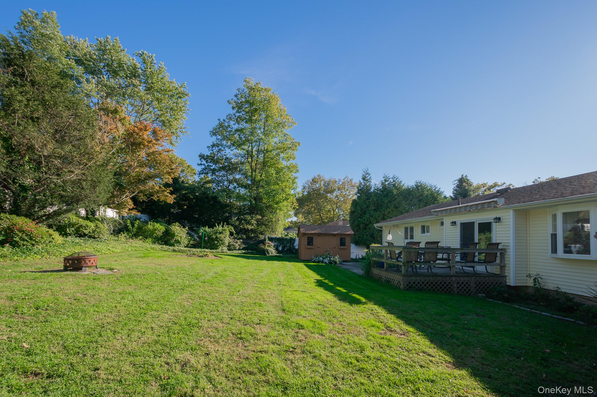 4 Manchester Drive Bethpage, NY 11714 - Photo 23 of 26 a view of a house with a backyard porch and sitting area