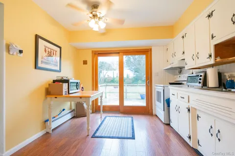 a large kitchen with stainless steel appliances a lot of counter space and a wooden floor