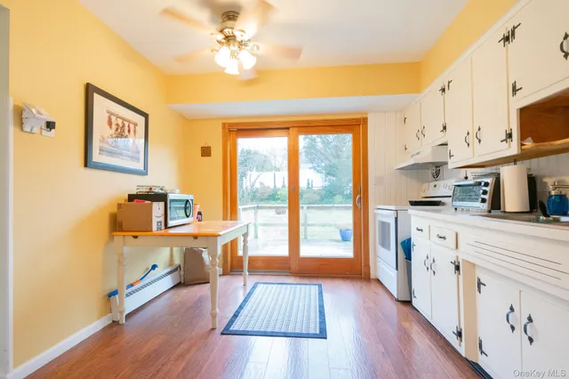 a large kitchen with stainless steel appliances a lot of counter space and a wooden floor