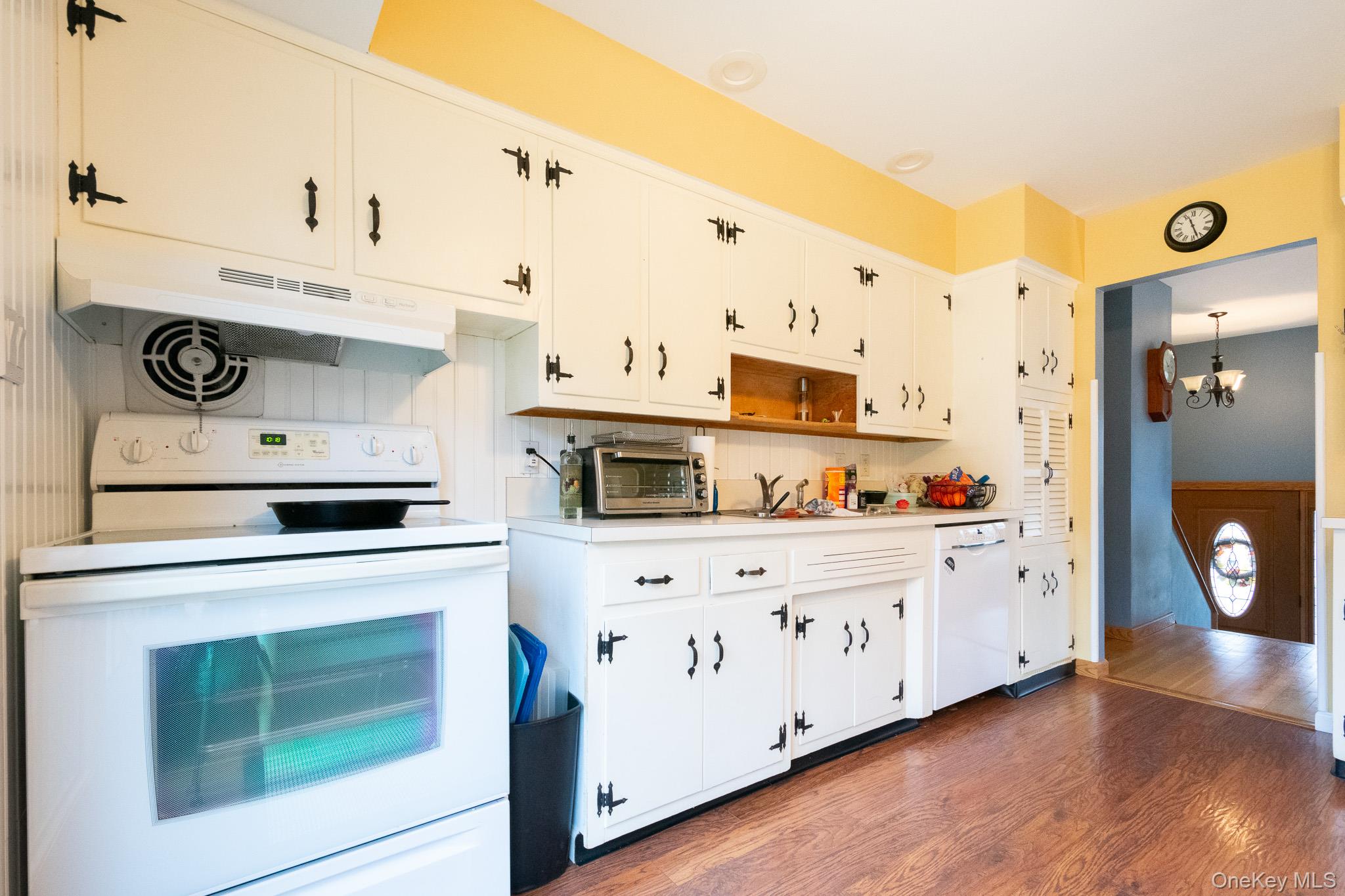 4 Manchester Drive Bethpage, NY 11714 - Photo 7 of 26 a kitchen with stainless steel appliances a stove a microwave and cabinets