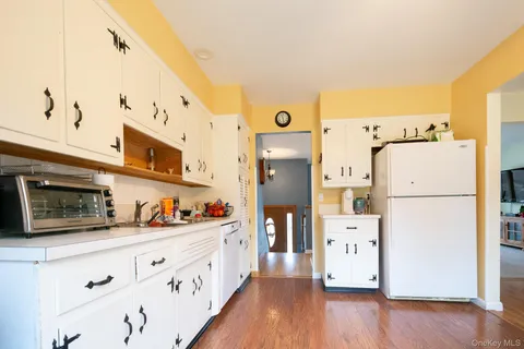 a kitchen with refrigerator and cabinets