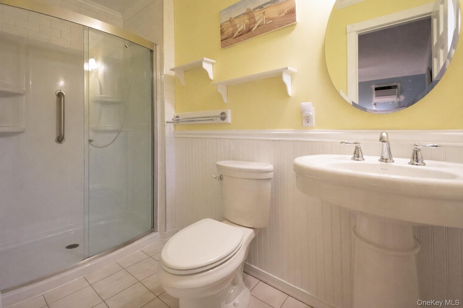 4 Manchester Drive Bethpage, NY 11714 - Photo 9 of 26 a bathroom with a sink a toilet and shower