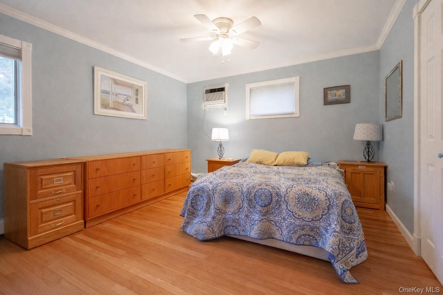 4 Manchester Drive Bethpage, NY 11714 - Photo 10 of 26 a bedroom with a bed and wooden floor