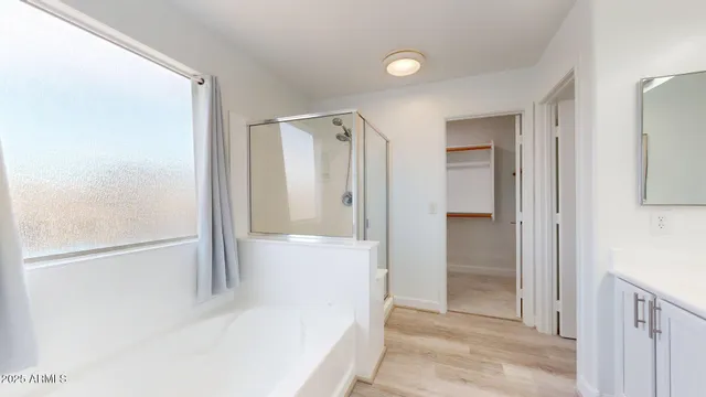 an empty room with a chandelier fan and a ceiling fan