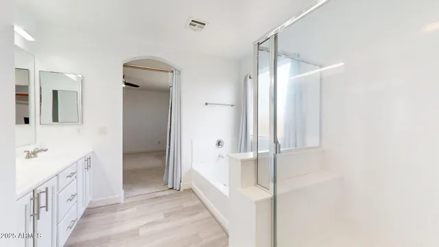 a bathroom with a double vanity sink and a mirror