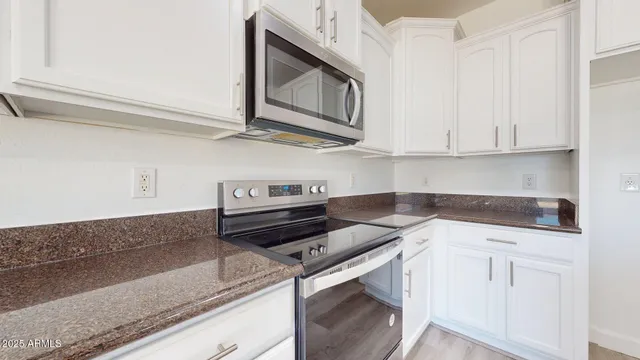 a kitchen with stainless steel appliances granite countertop a sink and cabinets