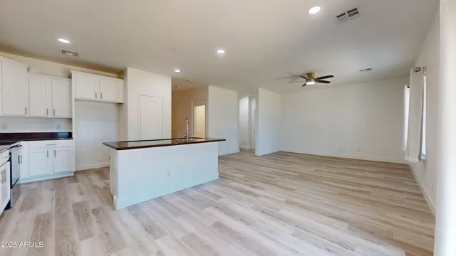a view of kitchen with refrigerator microwave and stove