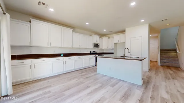 a view of kitchen with cabinets and wooden floor