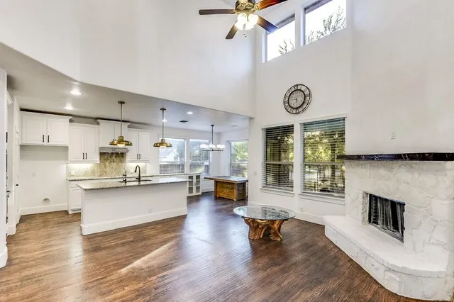 a living room with kitchen island furniture and a fireplace