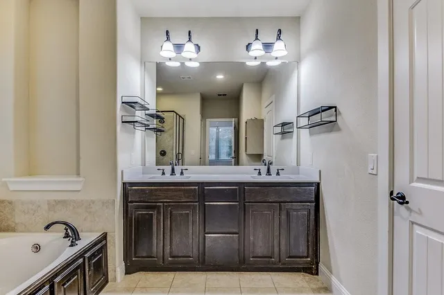 a spacious bathroom with a granite countertop sink a toilet and a mirror