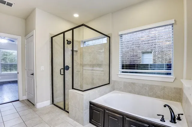 a bathroom with a bathtub and a shower
