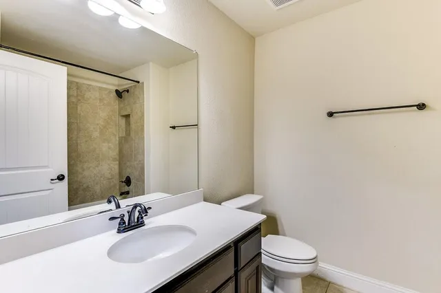 a bathroom with a sink toilet and shower