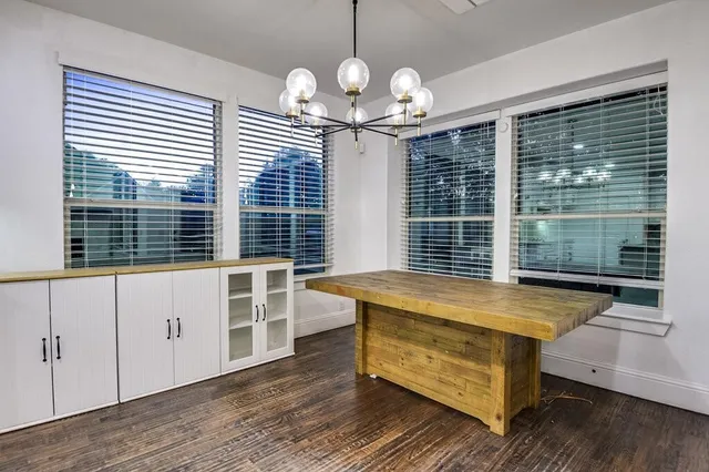 a view of a room with wooden floor and windows