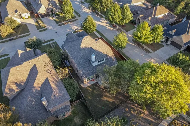 an aerial view of a house with a yard and garden