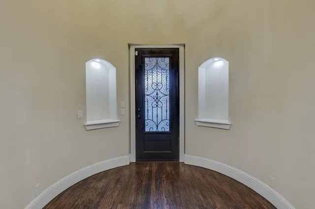 a view of an entryway with wooden floor