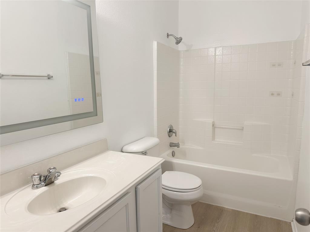 7537 Lazy Spur Boulevard Fort Worth, TX 76131 - Photo 12 of 24 a bathroom with a sink a toilet and shower
