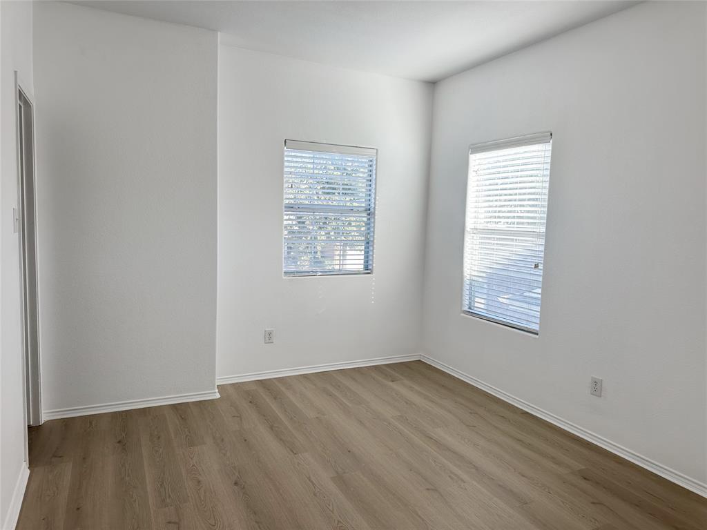 7537 Lazy Spur Boulevard Fort Worth, TX 76131 - Photo 15 of 24 a view of an empty room with wooden floor and a window