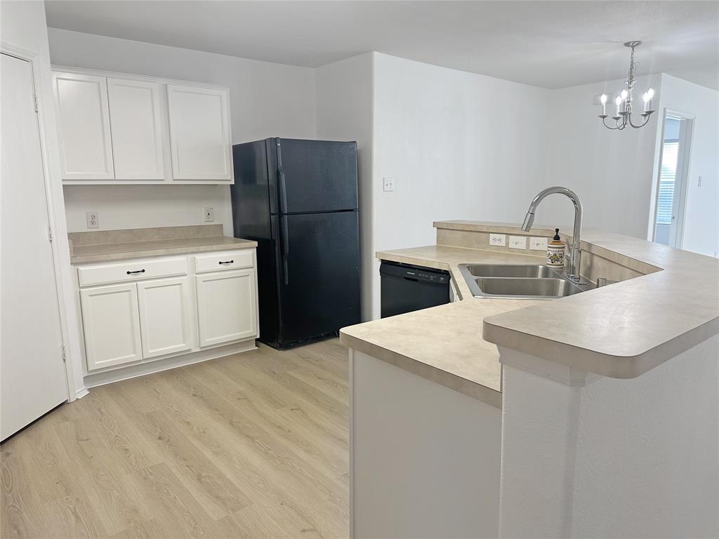 7537 Lazy Spur Boulevard Fort Worth, TX 76131 - Photo 17 of 24 a kitchen with stainless steel appliances granite countertop a refrigerator a sink a stove and white cabinets