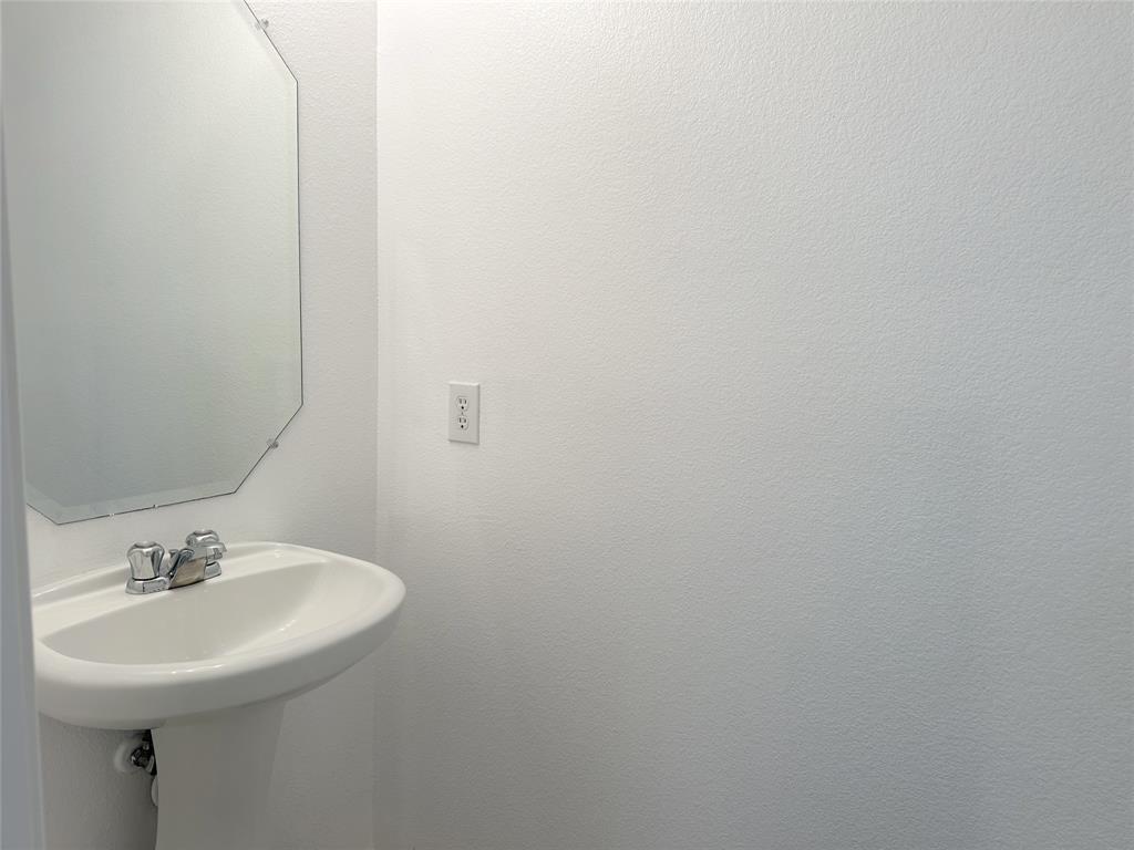 7537 Lazy Spur Boulevard Fort Worth, TX 76131 - Photo 20 of 24 a bathroom with a sink and a mirror