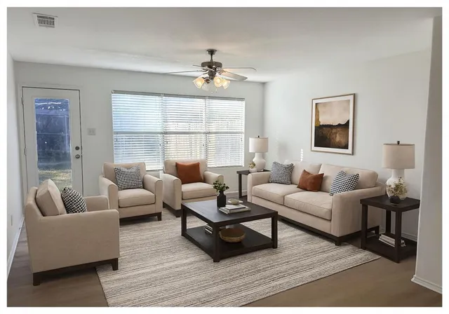 a living room with furniture and a large window