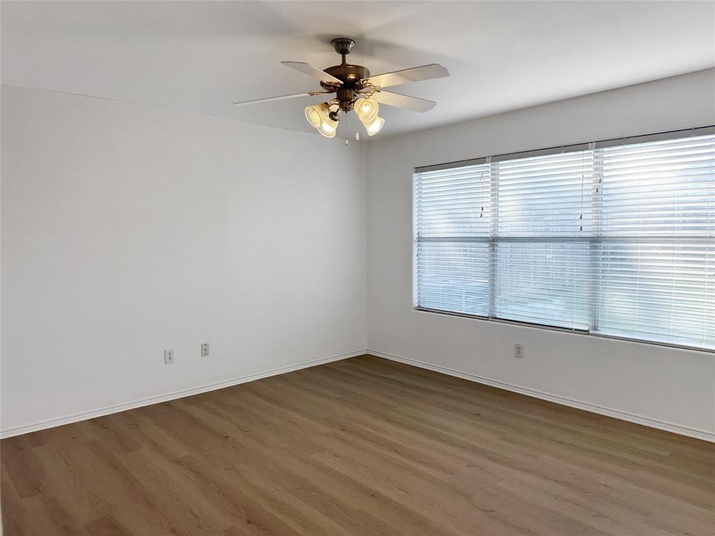 7537 Lazy Spur Boulevard Fort Worth, TX 76131 - Photo 22 of 24 wooden floor in an empty room with a window