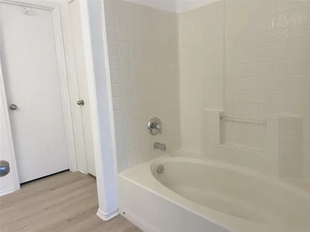 a bathroom with bathtub and shower