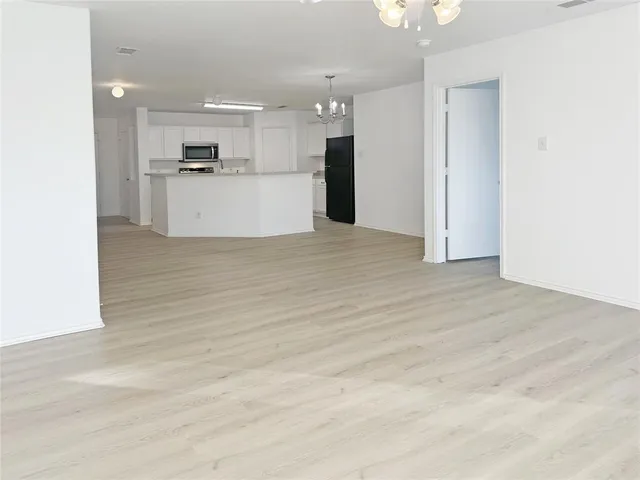 a view of a kitchen with a sink and a refrigerator