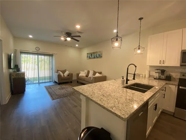 a kitchen with sink refrigerator and stove