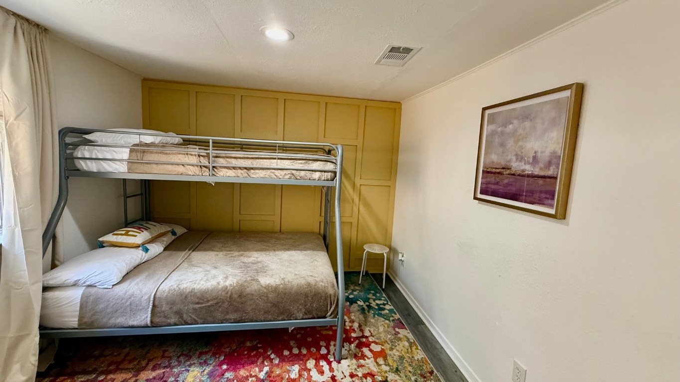 1802 East University Avenue, Unit A Georgetown, TX 78626 - Photo 7 of 11 a bedroom with a bed and wooden floor