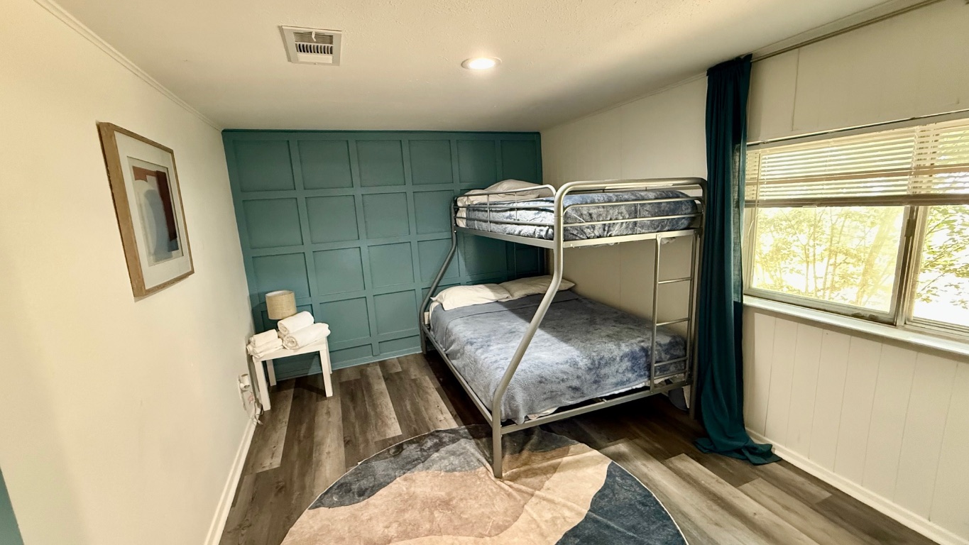 1802 East University Avenue, Unit A Georgetown, TX 78626 - Photo 8 of 11 a bedroom with a bed and a window