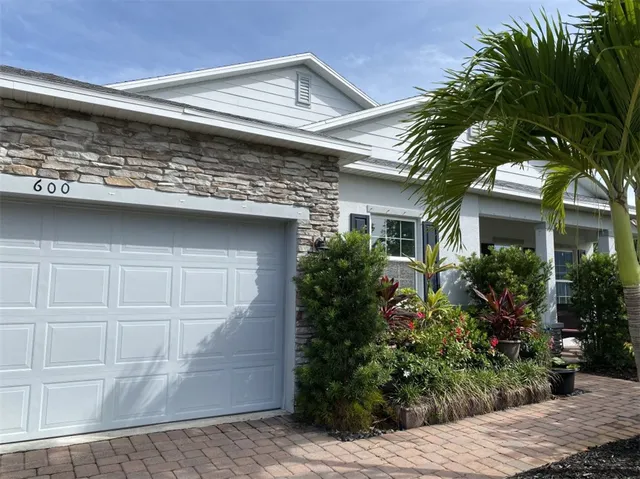a view of house with potted plants
