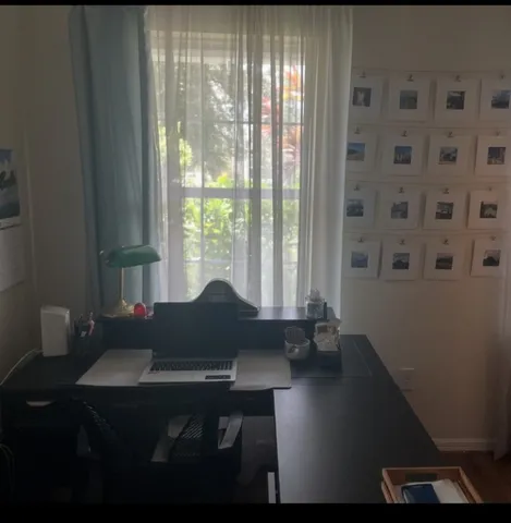 a table chair sitting in a bedroom next to a window