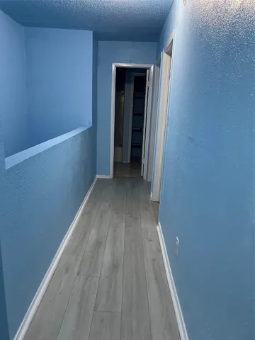 a view of a small space with wooden floor and a window