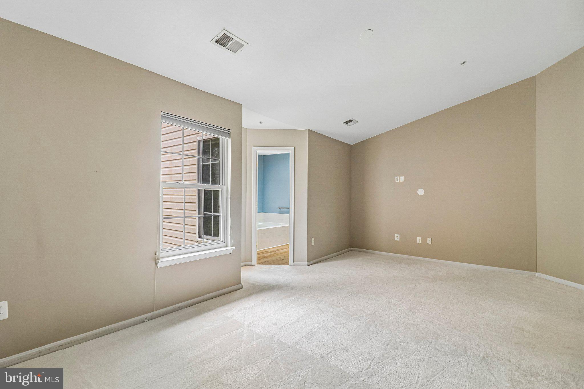 217 Braxton Way, Unit 217 Edgewater, MD 21037 - Photo 13 of 27 an empty room with windows