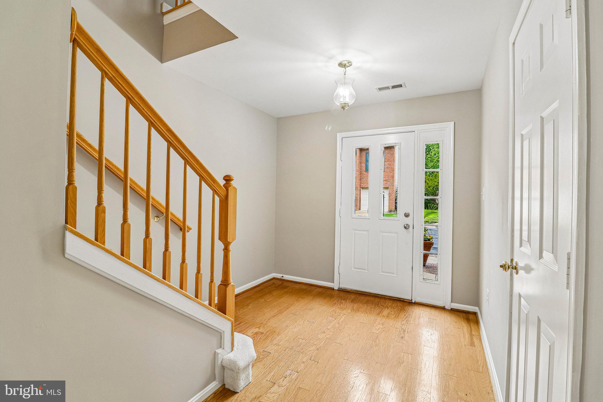 217 Braxton Way, Unit 217 Edgewater, MD 21037 - Photo 2 of 27 wooden floor in an empty room with a window