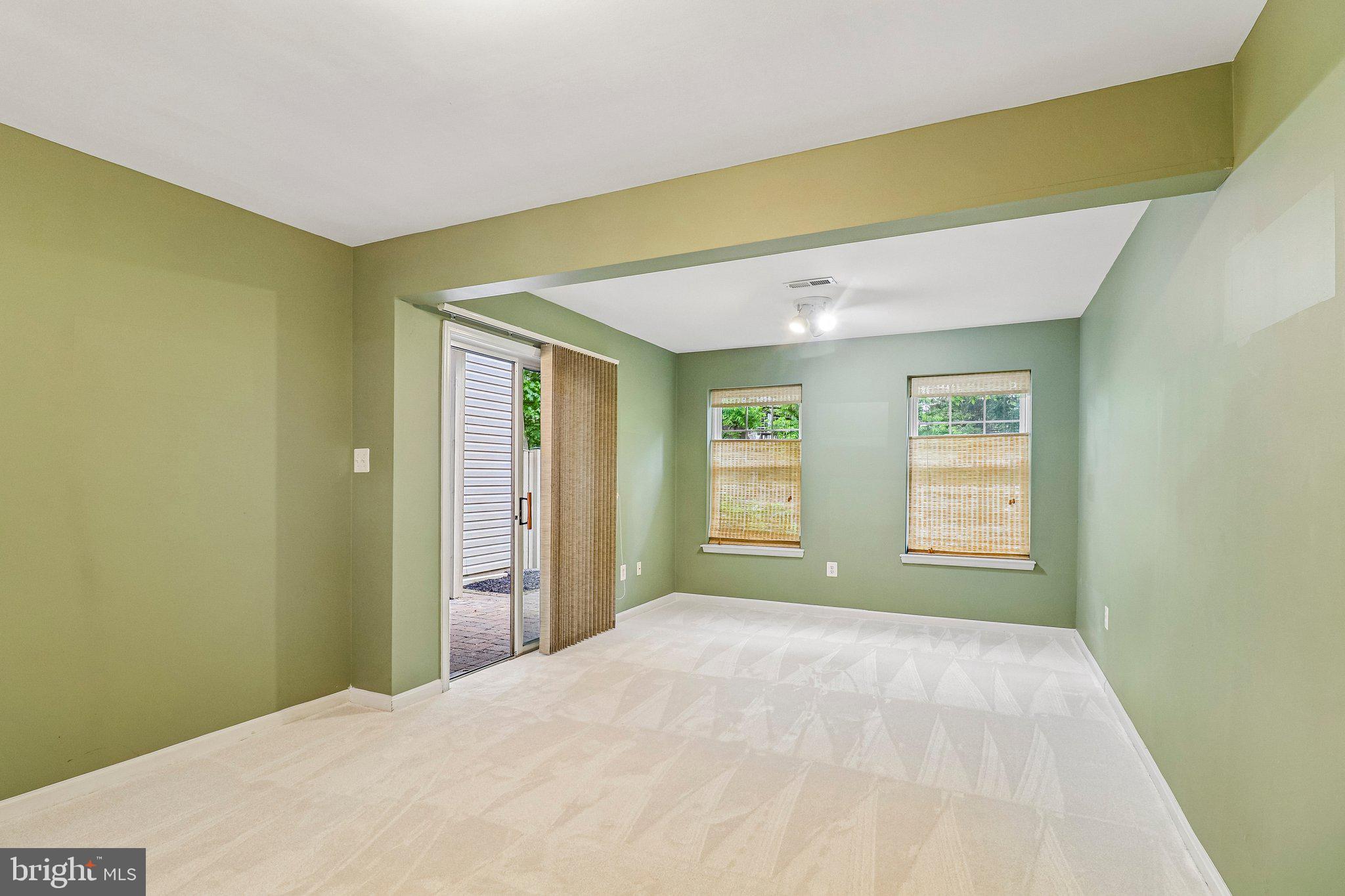 217 Braxton Way, Unit 217 Edgewater, MD 21037 - Photo 20 of 27 a view of a big room with windows and chandelier